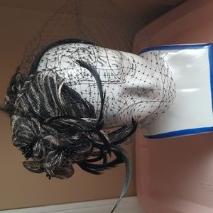 Animal print hat/ headband with mesh and feathers. Fascinator type hat.